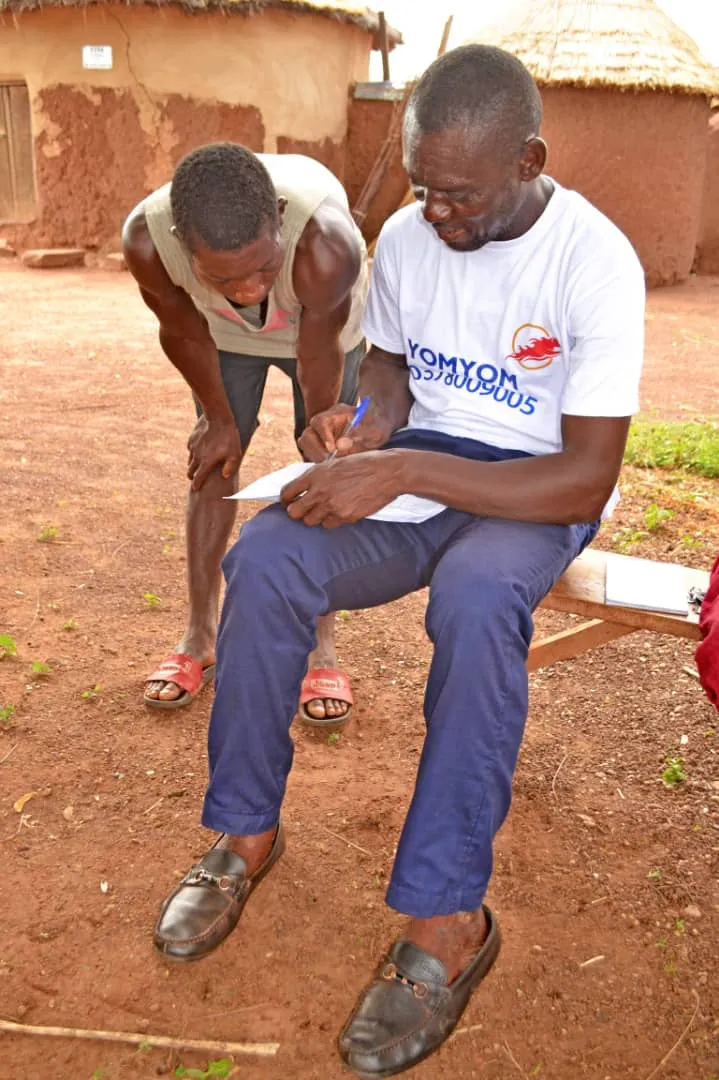 A YomYom agent recording a sale in a shea-picking community