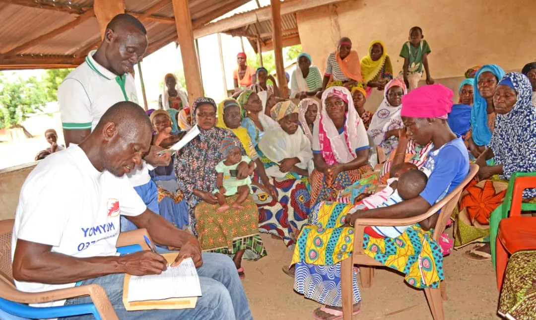 Registering women pickers at a community meeting