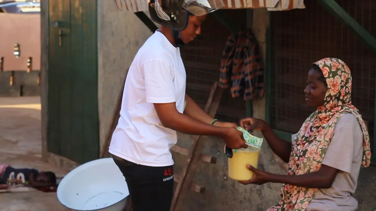 A rider collecting produce in a farming community